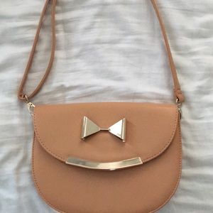Tan cross body bag with gold bow